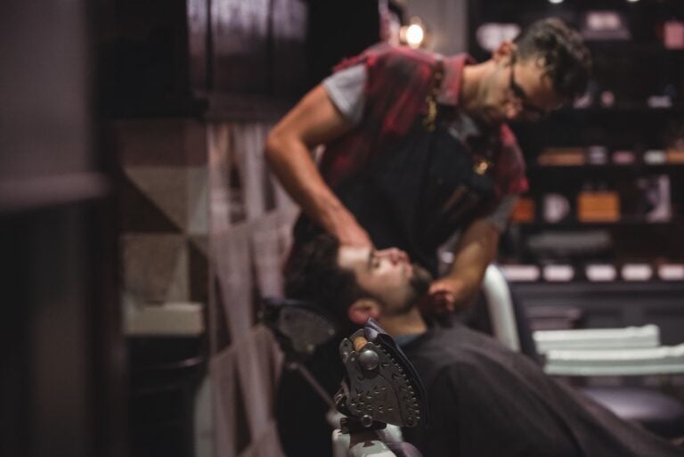 Barber working with a client