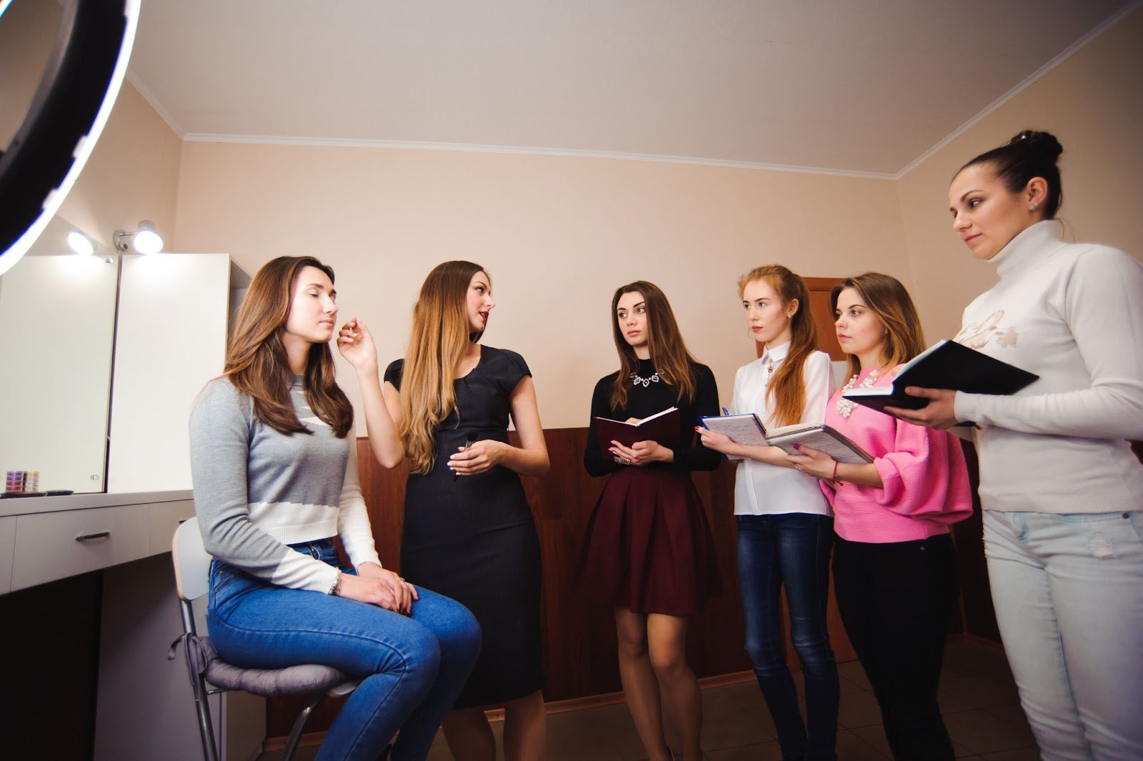 Is Cosmetology School Worth It? The Complete 2025 Guide with Real Data 5 Cosmetology instructor teaching a makeup lesson to students taking notes at Cosmetology & Spa Academy