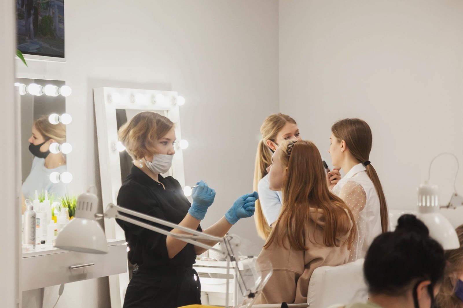 Is Cosmetology School Worth It? The Complete 2025 Guide with Real Data 1 Cosmetology students practicing makeup and skincare techniques in a classroom.