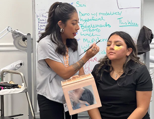 Teacher giving lessons to Cosmetology Student