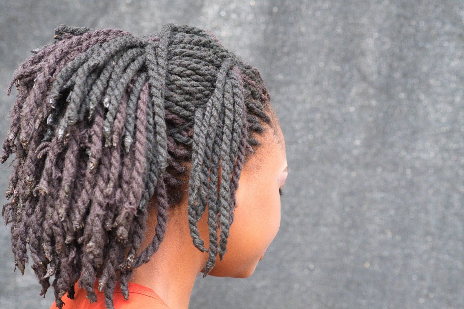 How To Braid African Hair: A Guide for New Cosmetologists 6 Back view of a woman with chunky two-strand twists styled into a short natural hairstyle.