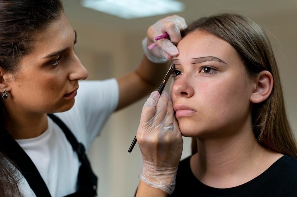 Brow technician working with a client.