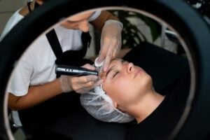 Person getting their eyebrows done by a professional eyebrow tech.