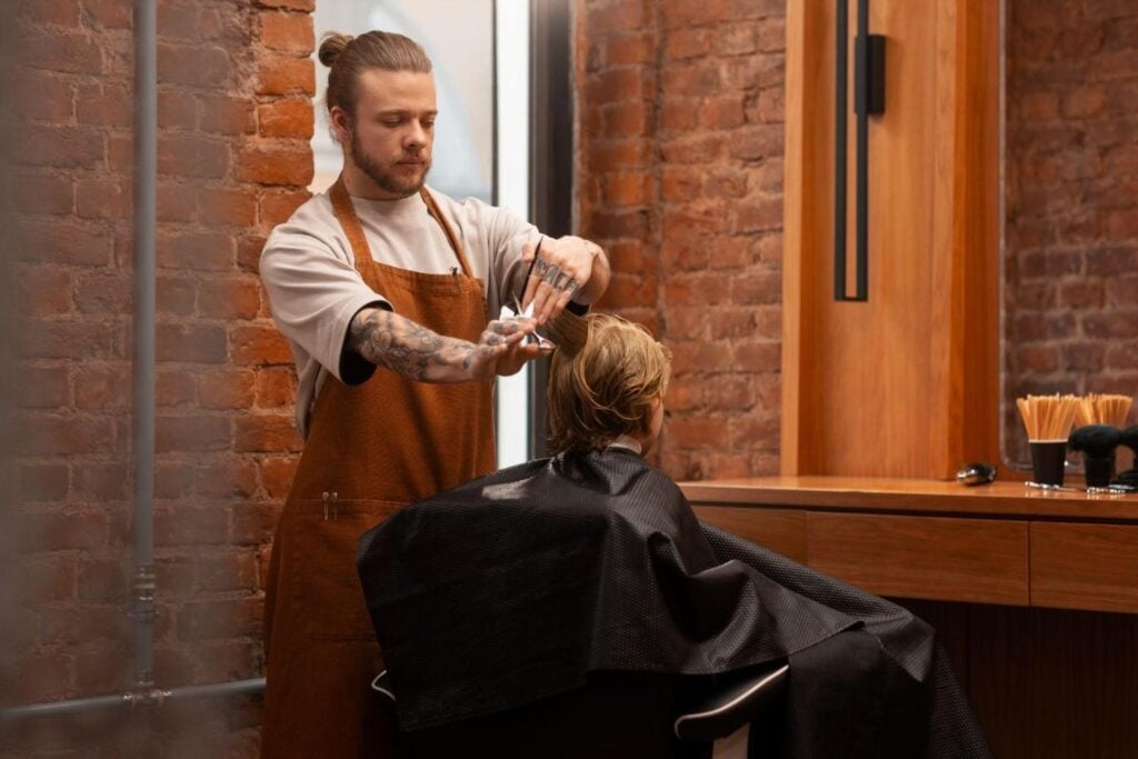 Barber school student practicing hair styling for kids.