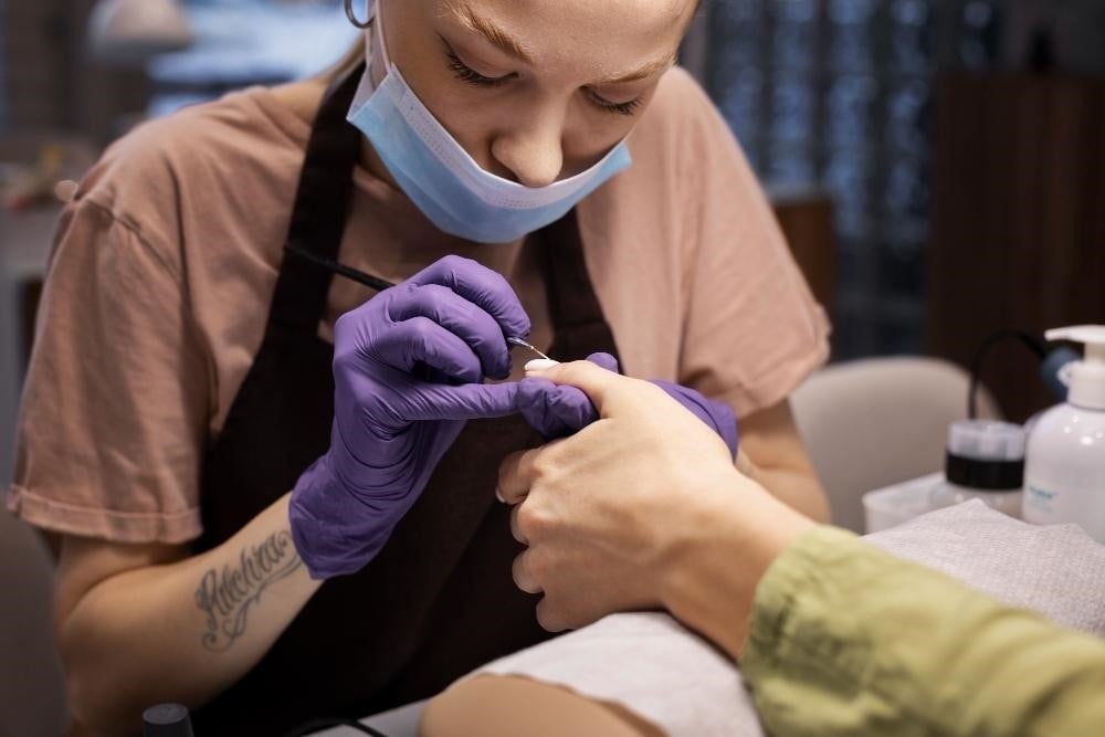 Nail tech student doing gel nails on a client.
