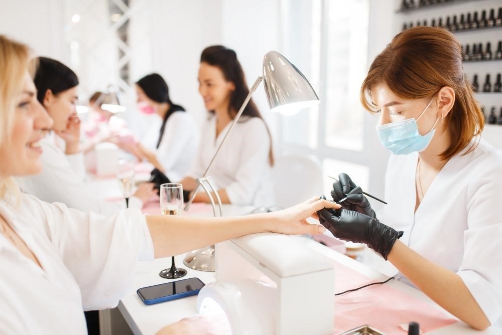 Nail technicians working at a nail salon.