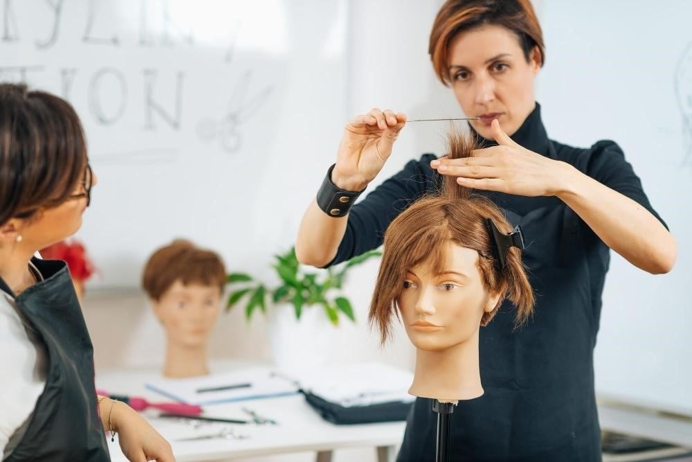 Is Beauty School Easier Than a Four-Year College? 3 A hair cutting class at a beauty school in Illinois