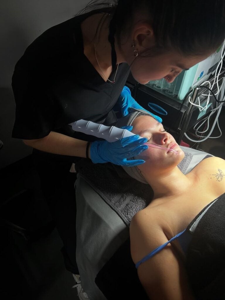 How to Become a Medical Esthetician 3 Student performing advanced skincare treatments on a client at our esthetician school in Illinois.