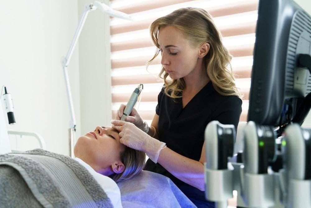 Medical esthetician student practicing advanced skincare treatments
