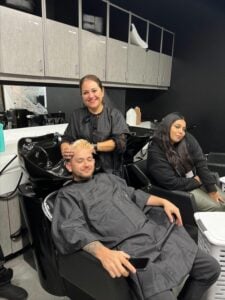 Cosmetology student learning professional shampoo and hair care techniques in the training salon at Cosmetology & Spa Academy, cosmetology school in Illinois.