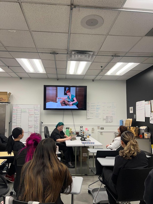 Esthetics students attending a classroom lesson on hair removal techniques at Cosmetology & Spa Academy in Illinois.