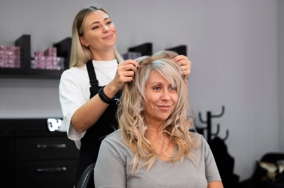 Hair expert working on client hair at salon