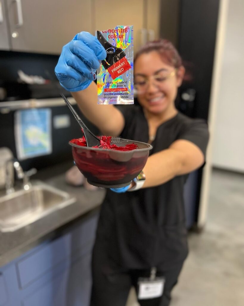 Student showing her color mix at hair school training