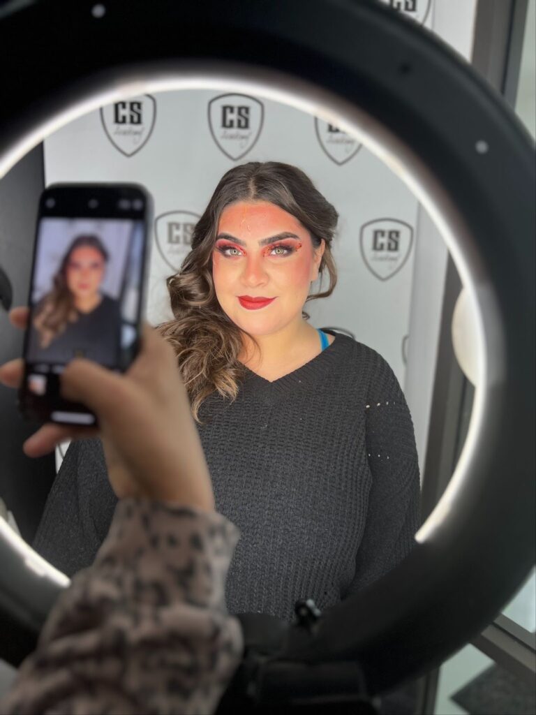 Girl taking photo in the mirror at hair salon after face treatment