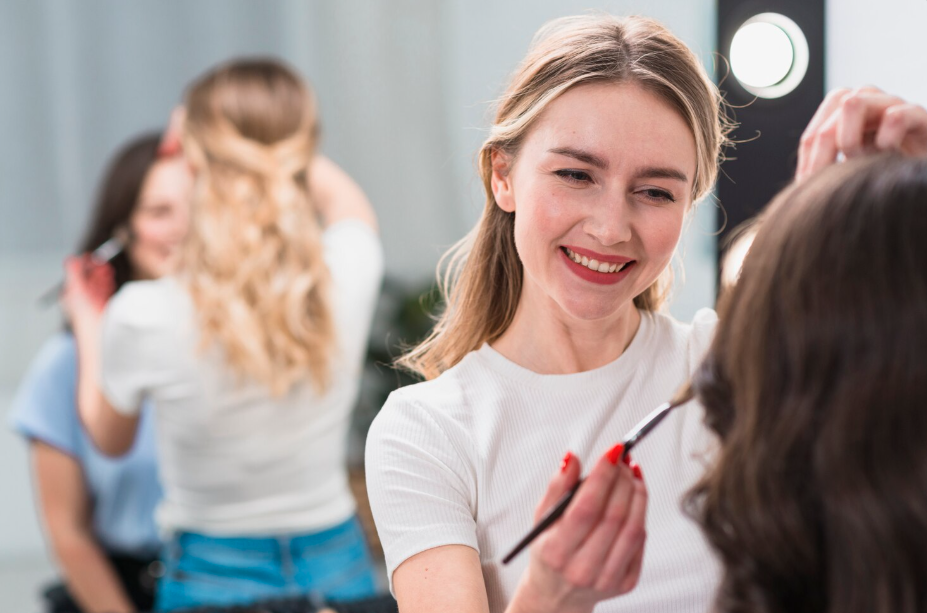 Woman applying makeup to another woman.