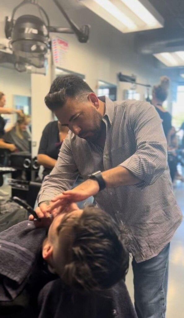 Barber trimming training at Cosmetology and Spa Academy, a barber school in Illinois