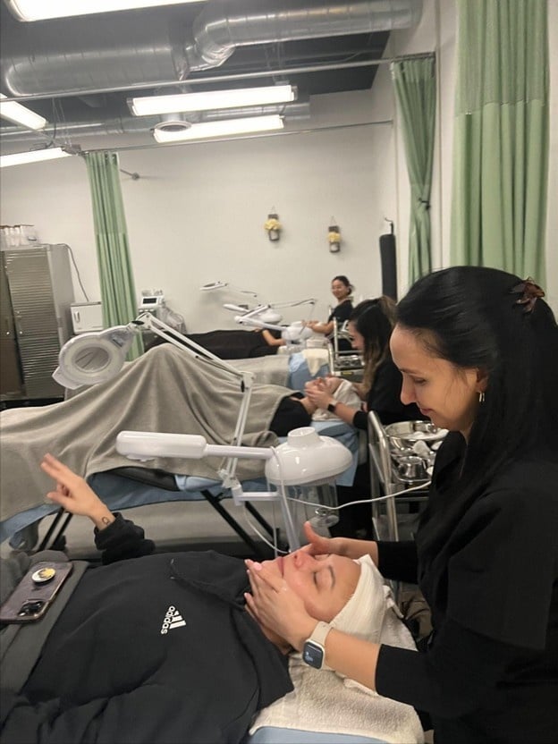 esthetician program in Illinois at Cosmetology and Spa Academy, students learning about skin care treatments 