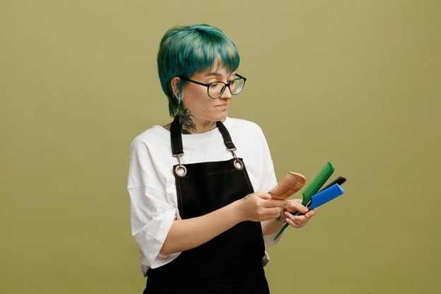 cosmetology school student looking at hair styling tools